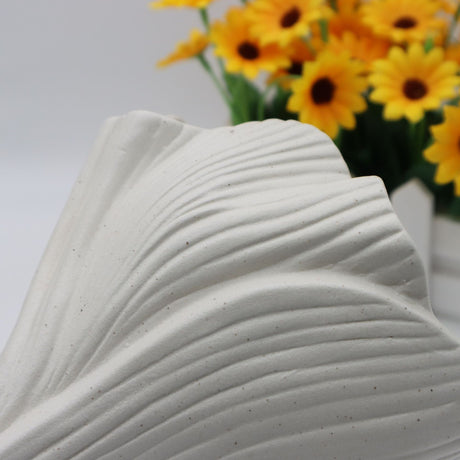 Beige sculptural ceramic vase with wide fluted opening