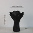 Black sculptural ceramic vase with wide fluted opening