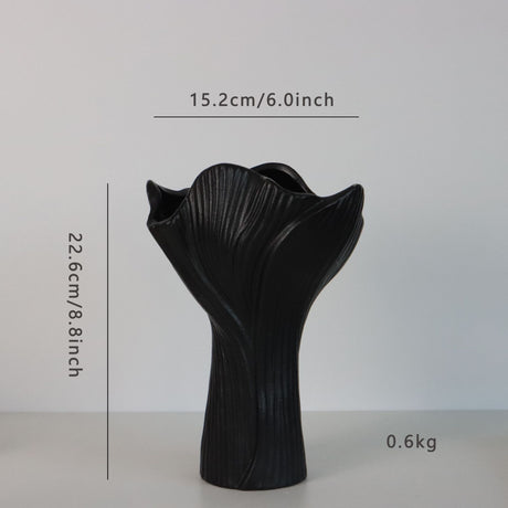 Black sculptural ceramic vase with wide fluted opening