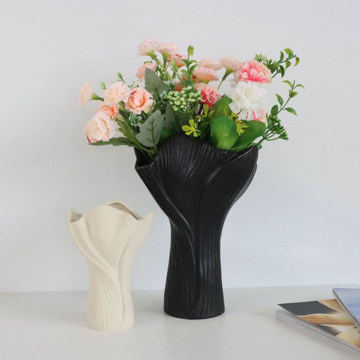 Black sculptural ceramic vase with wide fluted opening