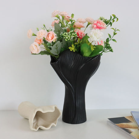 Black sculptural ceramic vase with wide fluted opening