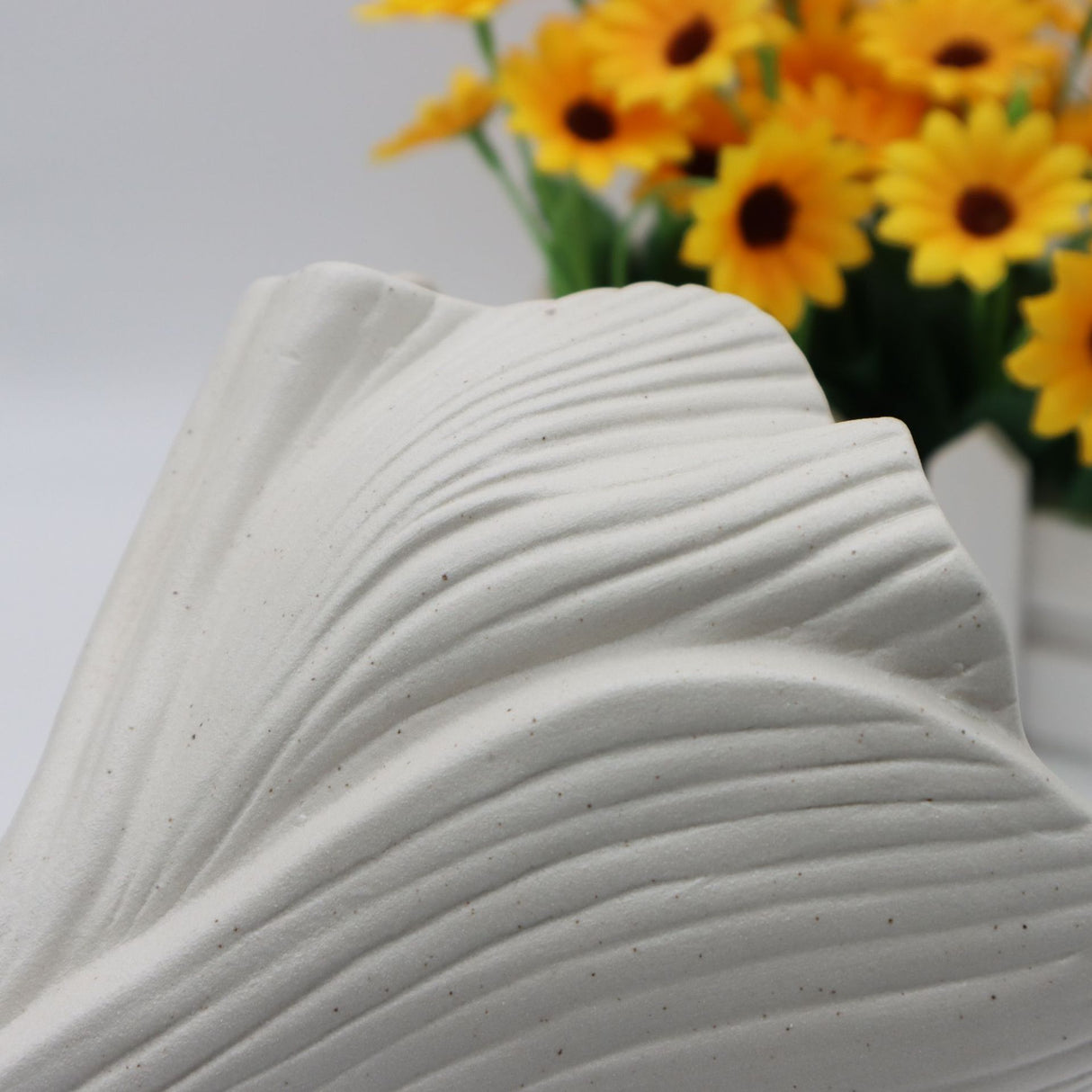Black sculptural ceramic vase with wide fluted opening