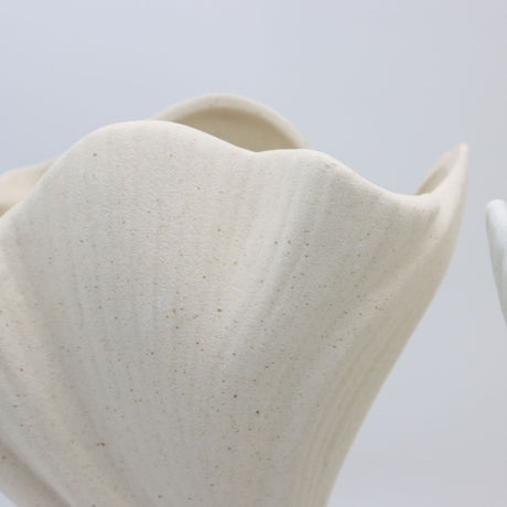 Black sculptural ceramic vase with wide fluted opening