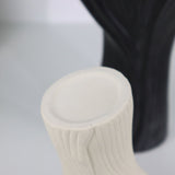 Black sculptural ceramic vase with wide fluted opening