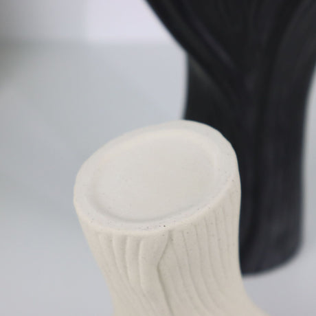 Black sculptural ceramic vase with wide fluted opening