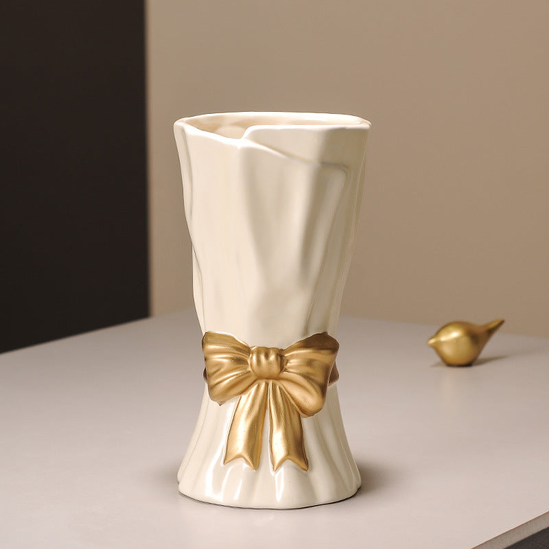 Cream ceramic vase with golden bow