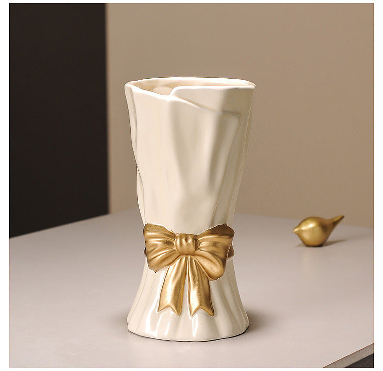 Cream ceramic vase with golden bow