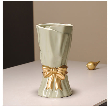 Cream ceramic vase with golden bow
