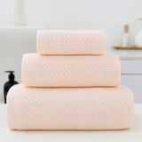 Three piece light pink waffle weave cotton towel set with bath towel, hand towel and face cloth