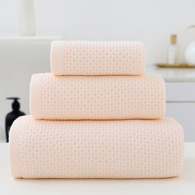 Three piece light pink waffle weave cotton towel set with bath towel, hand towel and face cloth