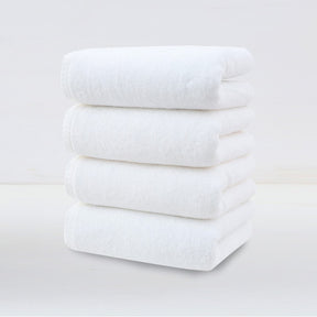 Four pack of white plush cotton hand towels folded and stacked
