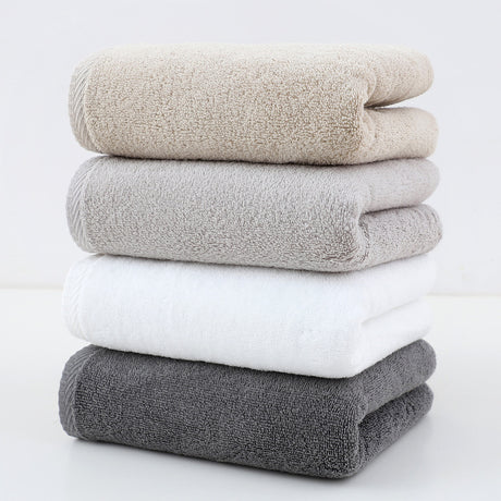 Set of 4 plush cotton hand towels in mixed colours, folded and stacked