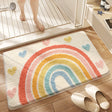 Plush quick dry bath mat in a bright rainbow design on a bathroom floor