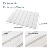 Dark grey drain mat folded in half to show its compact storage size
