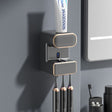 Grey wall mounted automatic toothpaste dispenser with UV steriliser and toothbrush holder