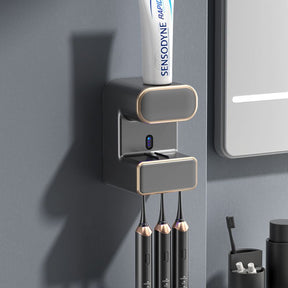 Grey wall mounted automatic toothpaste dispenser with UV steriliser and toothbrush holder