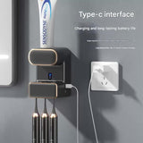 Toothpaste being dispensed automatically onto a toothbrush held under the grey sensor unit
