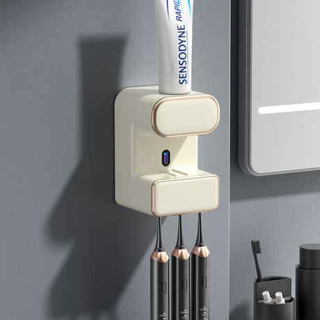 Beige wall mounted automatic toothpaste dispenser with UV steriliser and toothbrush holder