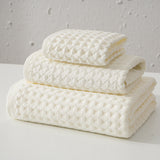Three piece white waffle weave cotton towel set with bath towel, hand towel and washcloth