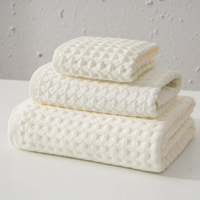 Three piece white waffle weave cotton towel set with bath towel, hand towel and washcloth