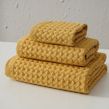 Three piece yellow waffle weave cotton towel set with bath towel, hand towel and washcloth