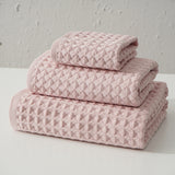 Three piece pink waffle weave cotton towel set with bath towel, hand towel and washcloth