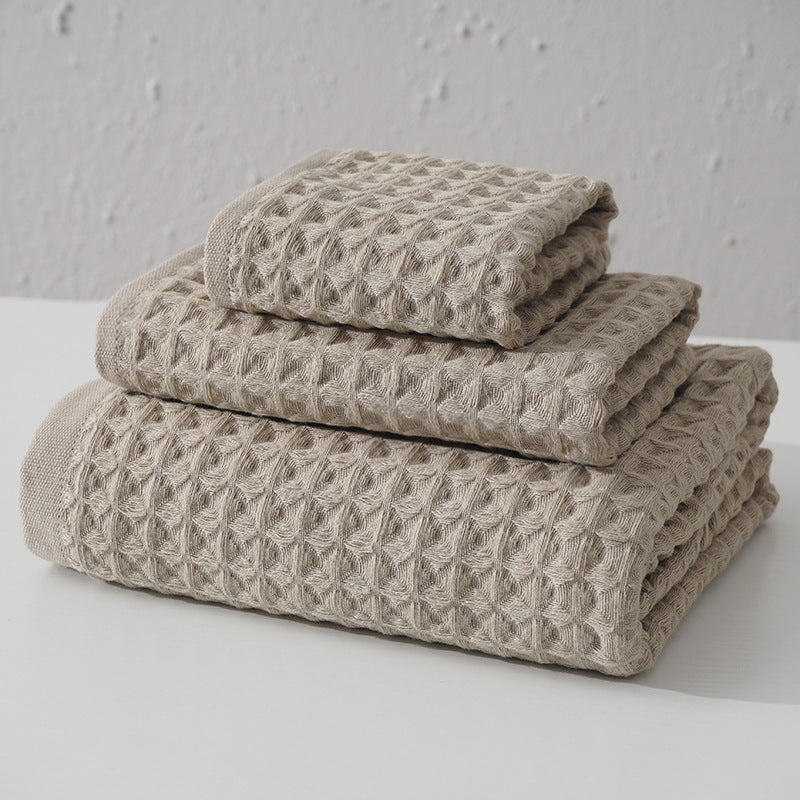 Three piece light brown waffle weave cotton towel set with bath towel, hand towel and washcloth