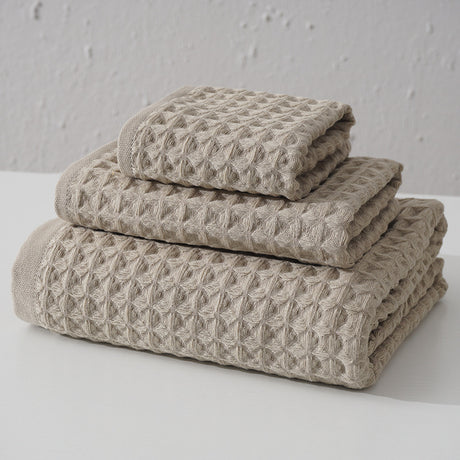 Three piece light brown waffle weave cotton towel set with bath towel, hand towel and washcloth