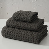 Three piece dark brown waffle weave cotton towel set with bath towel, hand towel and washcloth