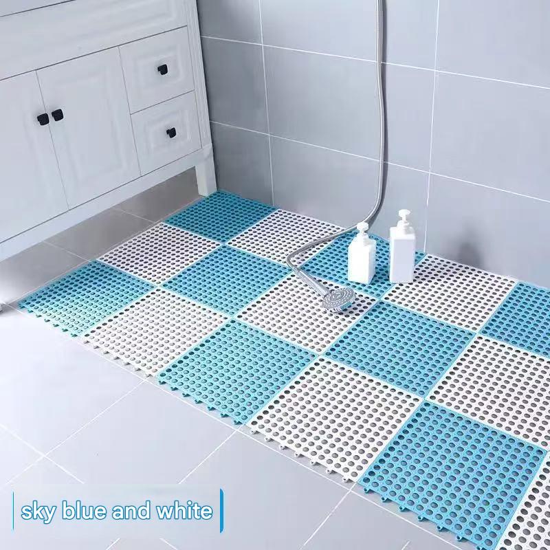 Sky blue and white interlocking non slip PVC floor tiles laid across a shower floor