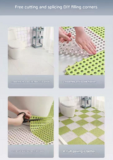 Green and pink drainage tiles laid across a wet bathroom floor