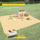 Grange yellow lightweight picnic mat 1.5 x 2m folded beside its drawstring bag showing printed top and reflective aluminium foil base