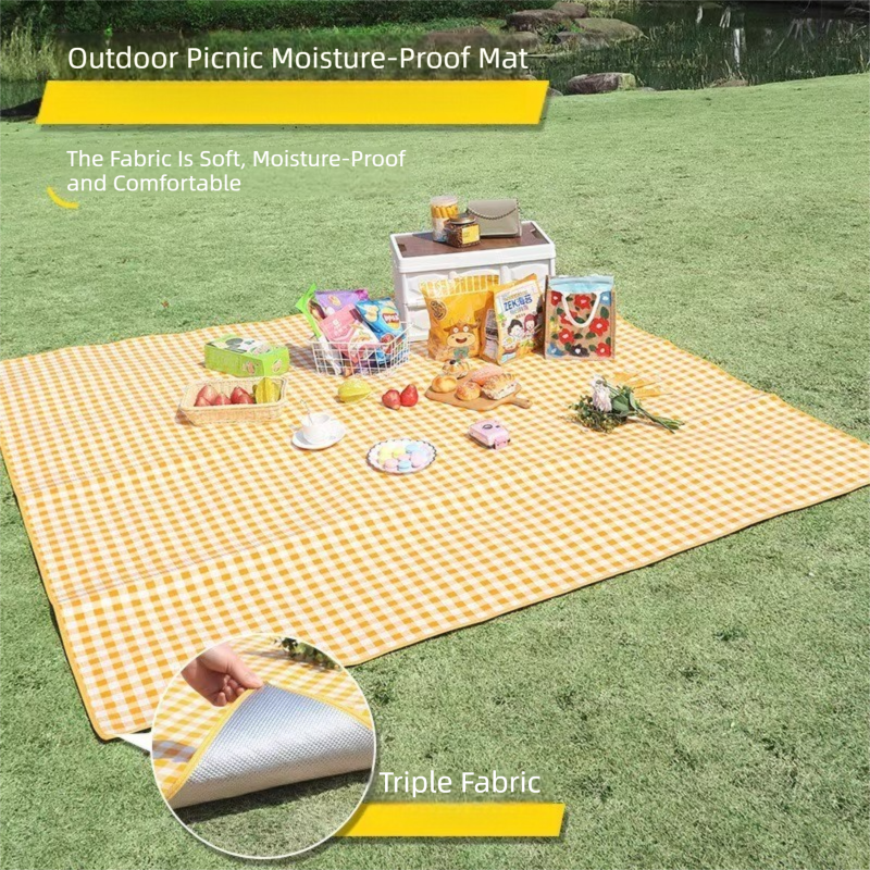 Grange yellow lightweight picnic mat 2 x 2m folded beside its drawstring bag showing printed top and reflective aluminium foil base