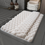 Checkered beige memory foam bath mat with integrated foot drying panel