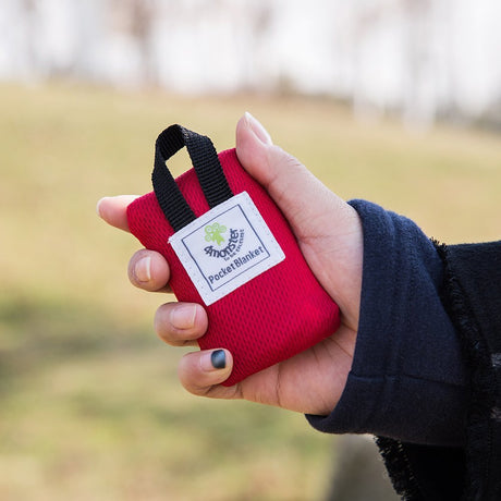 Red compact pocket picnic blanket folded into pouch