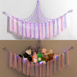 Corner plush toy storage hammock with purple ribbon accent