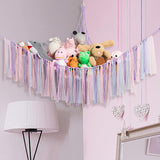 Corner plush toy storage hammock with purple ribbon accent