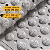 Close up of raised massage points and drainage holes on the khaki bath mat