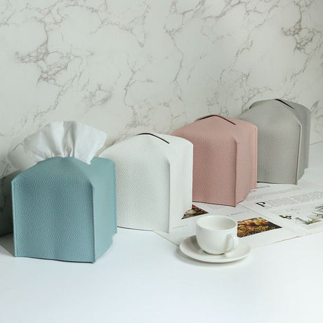 Pink tissue box cover with paper feeding through the top opening