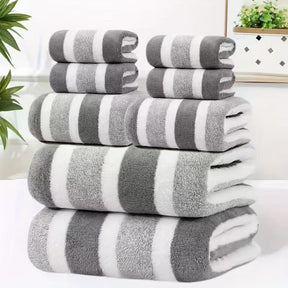 Eight piece grey coral fleece towel set with bath sheets, towels and face cloths in a wide stripe texture
