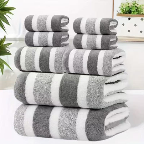 Eight piece grey coral fleece towel set with bath sheets, towels and face cloths in a wide stripe texture