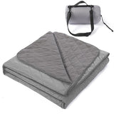 Grasmere double layer fleece picnic blanket in grey folded beside its zippered shoulder carry bag on grass