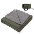 Grasmere double layer fleece picnic blanket in dark green folded beside its zippered shoulder carry bag on grass