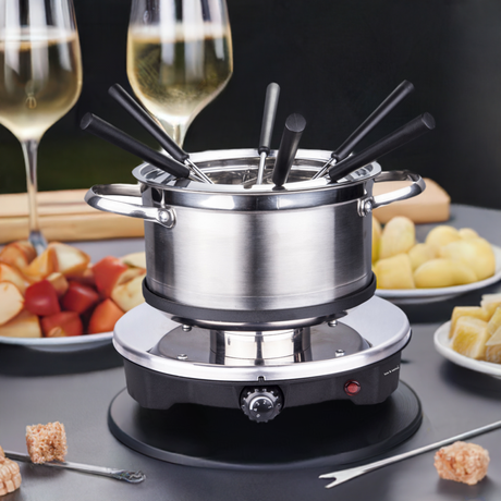 Fondue set components laid out including pot, covers and forks