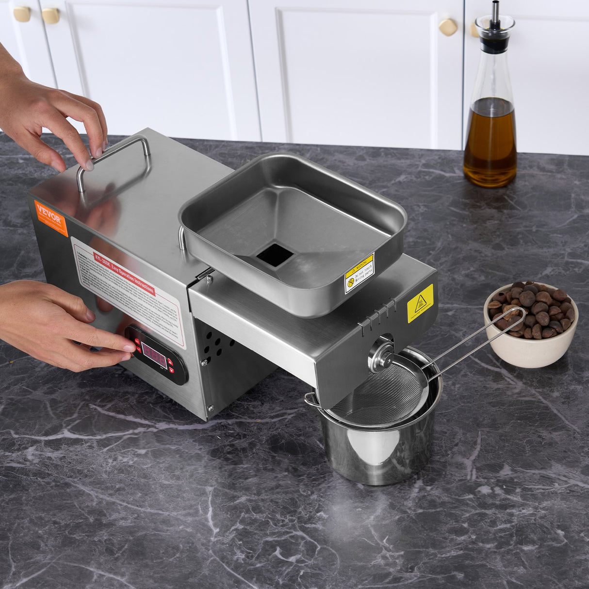 Freshly pressed oil flowing from the outlet of the machine