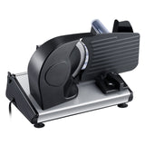 Electric meat slicer on a kitchen bench with sliced cold cuts
