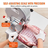 Frozen meat being cut on the bandsaw cutting table