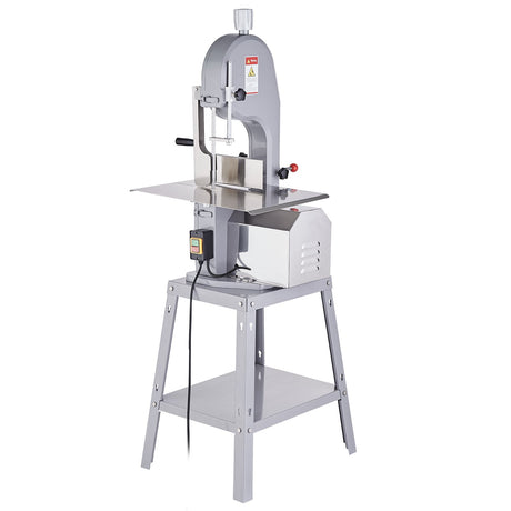 Meat bandsaw in a butcher shop on a stainless steel work bench