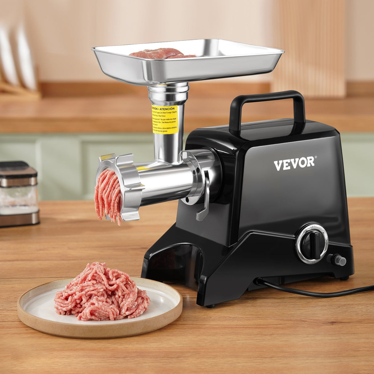 Minced meat coming out of the grinder head into a tray