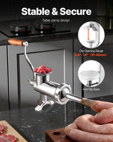 Stainless steel hand crank meat grinder clamped to a benchtop